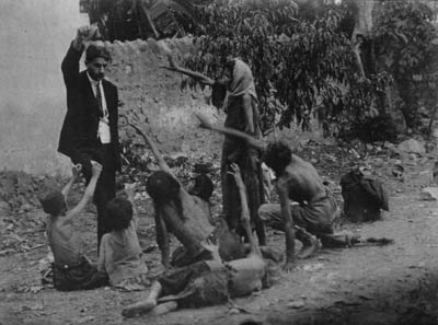 Armenian Genocide Pictures - Turk official teasing Armenian starved children by showing bread
